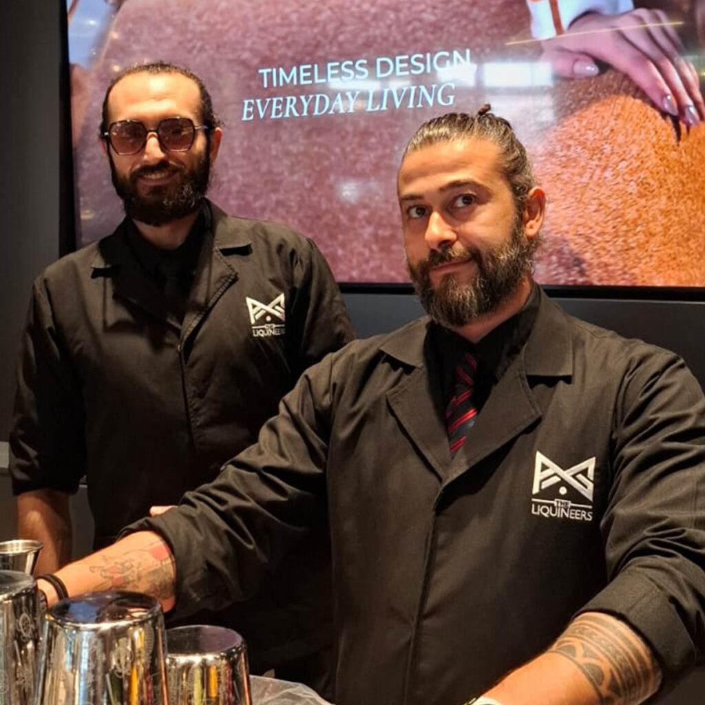 The LiquiNeers mixologists behind an event bar