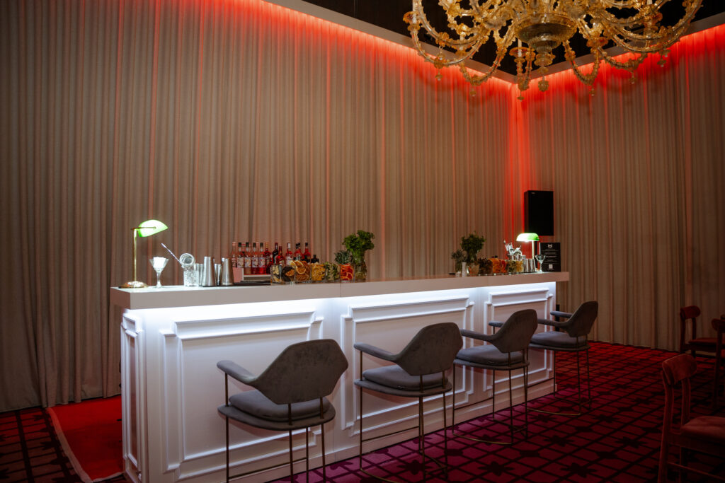 White-panelled Benito mobile bar with under-counter lighting at an event.