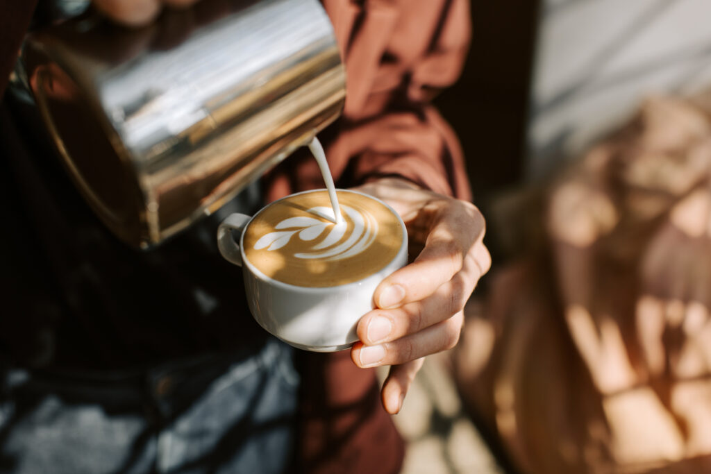 Coffee being poured into a cup during professional barista service.
