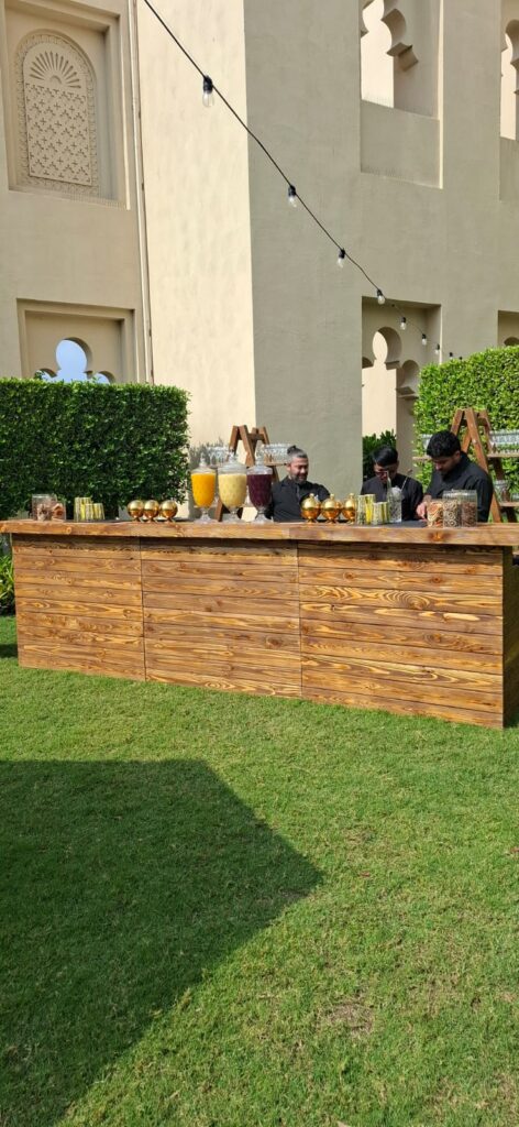 The LiquiNeers team behind a wooden mocktail bar at a Dubai Holding corporate event