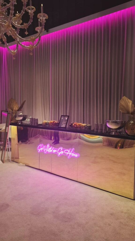 Gold-finished Goldy mobile bar illuminated at an event.