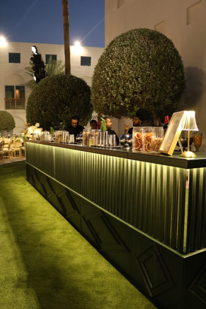 Metallic Nairobi modular bar with vertical illuminated lines at an event.