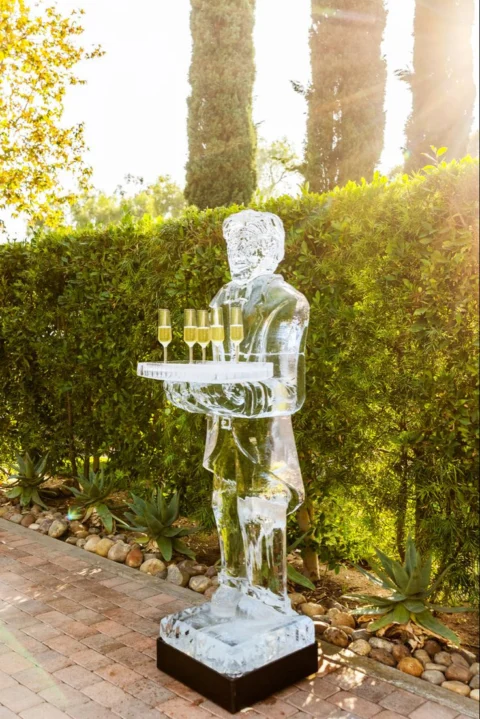 Sculpted ice figure used as a decorative beverage display at an event.